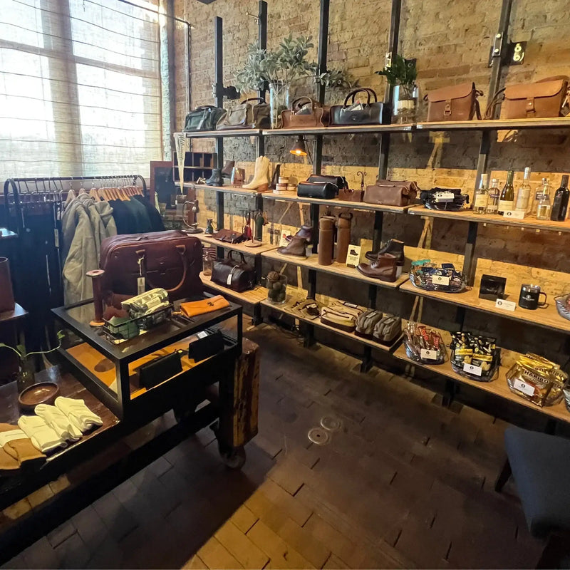 Rustic store interior with leather boots, bags, jackets, and accessories on display shelves
