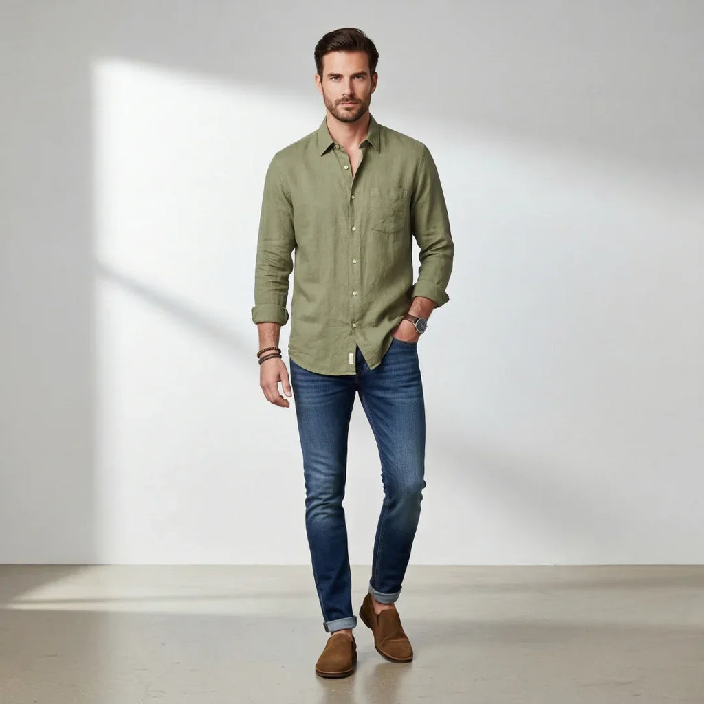 Man wearing whiskey suede boots, olive long sleeve shirt, and blue jeans indoors