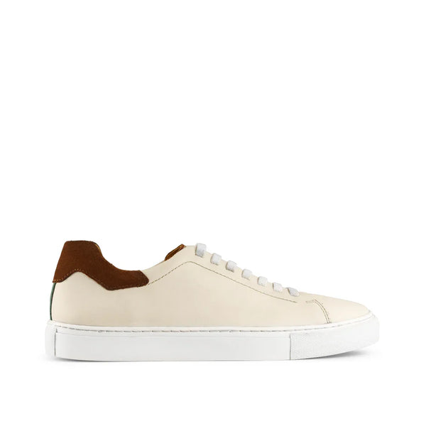 Men’s off-white leather sneaker with brown suede heel accent and white sole on white background