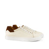 Men's cream leather sneakers with brown suede heel detail, white sole and laces