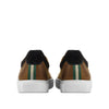 Rear view of brown leather sneakers with white soles, green and white striped heel detail