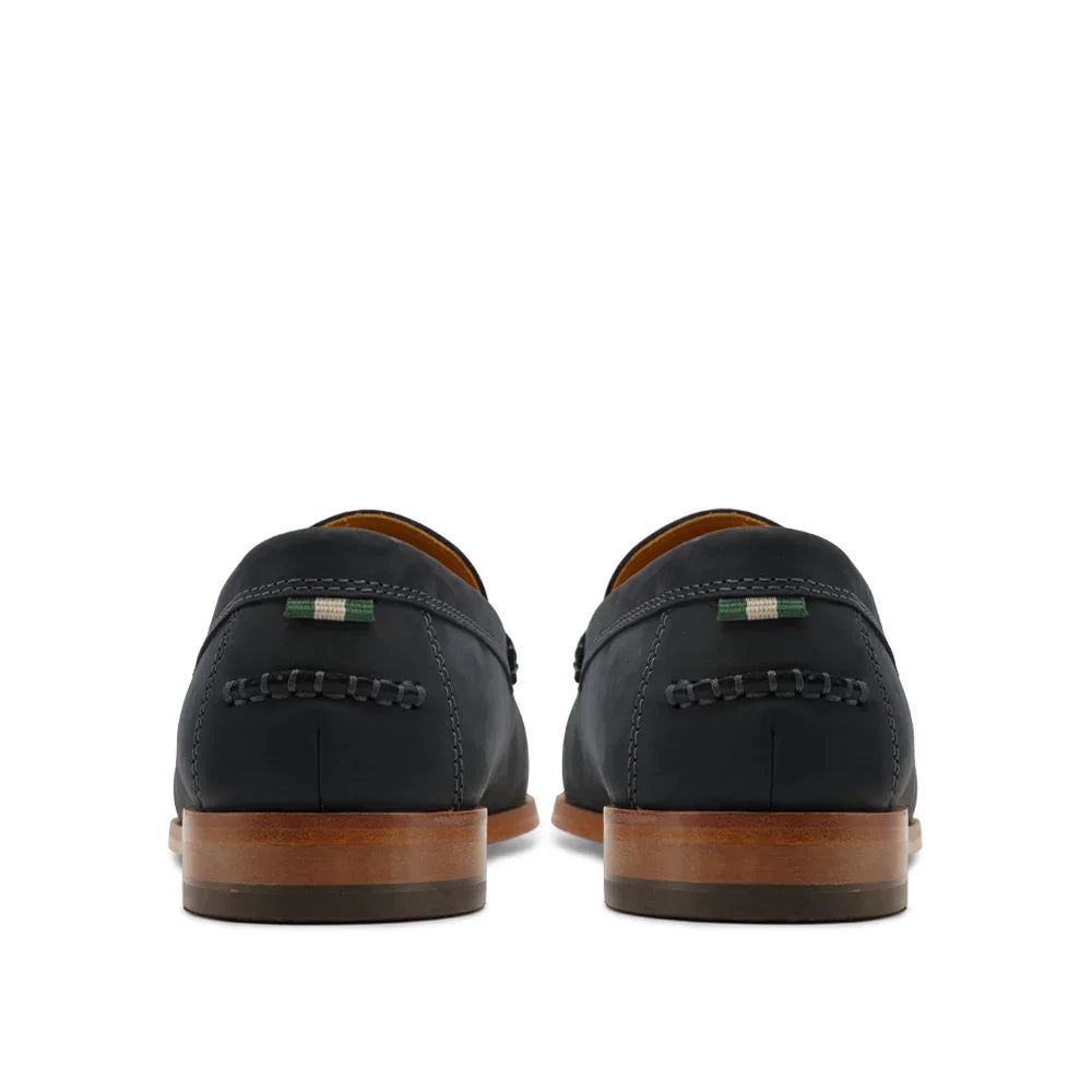 Rear view of men's black leather loafers with wooden soles on a white background.