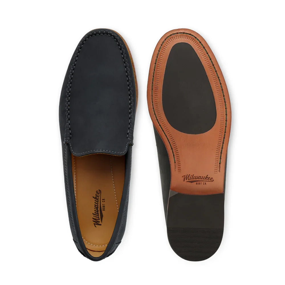 Men's black leather loafer with moc toe, front and sole view on white background.