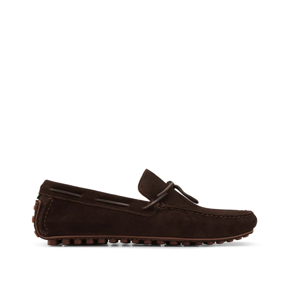 Dark brown suede driving loafer with moc toe and rubber sole, side profile on white background.