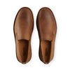 Pair of camel brown leather slip-on boots on a white background, top view.