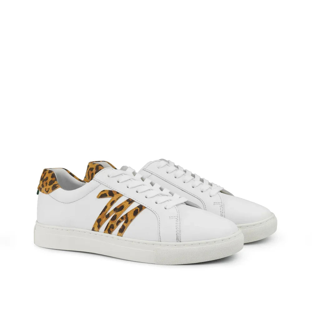 White low-top sneakers with leopard print accents and rubber soles on a white background