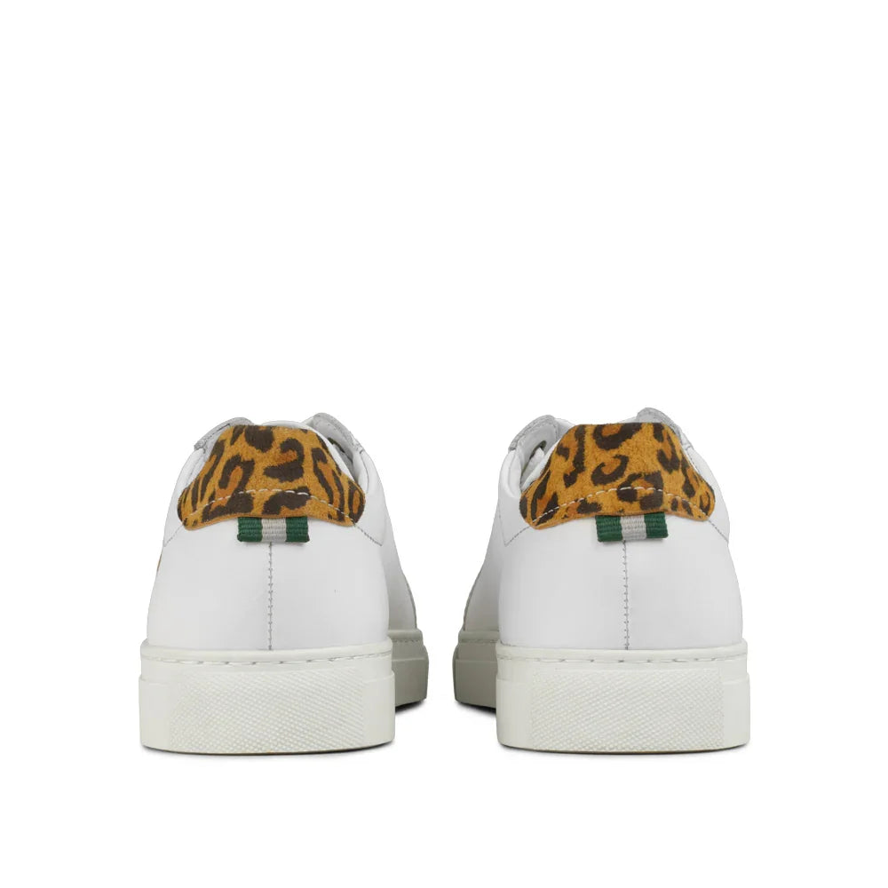 White leather sneakers with leopard print heel accent and green pull tab, rear view