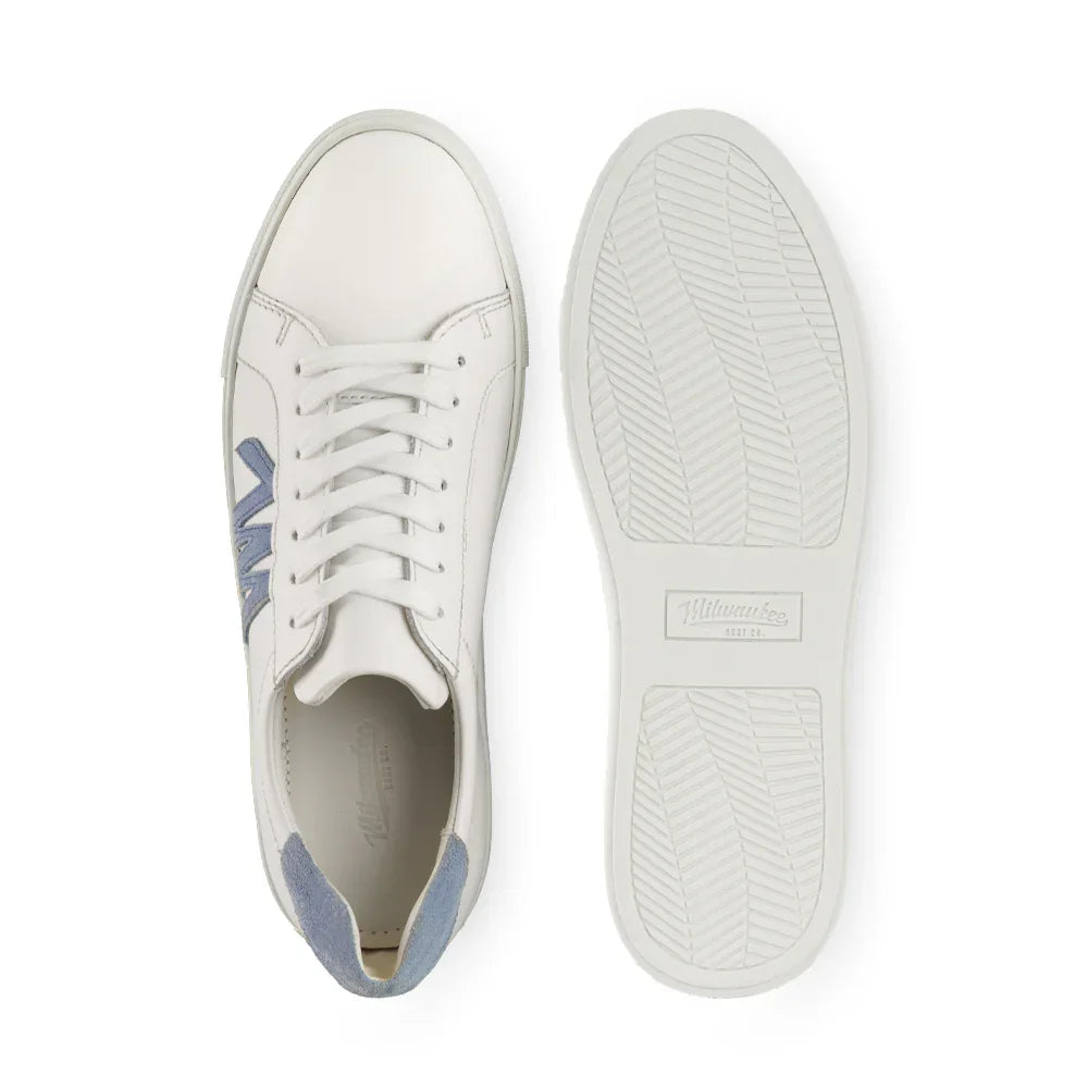 White leather sneaker with light blue suede accents, side logo, and rubber sole, top and bottom view