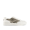 White low-top sneaker with black zebra stripe pattern side panel, lace-up design