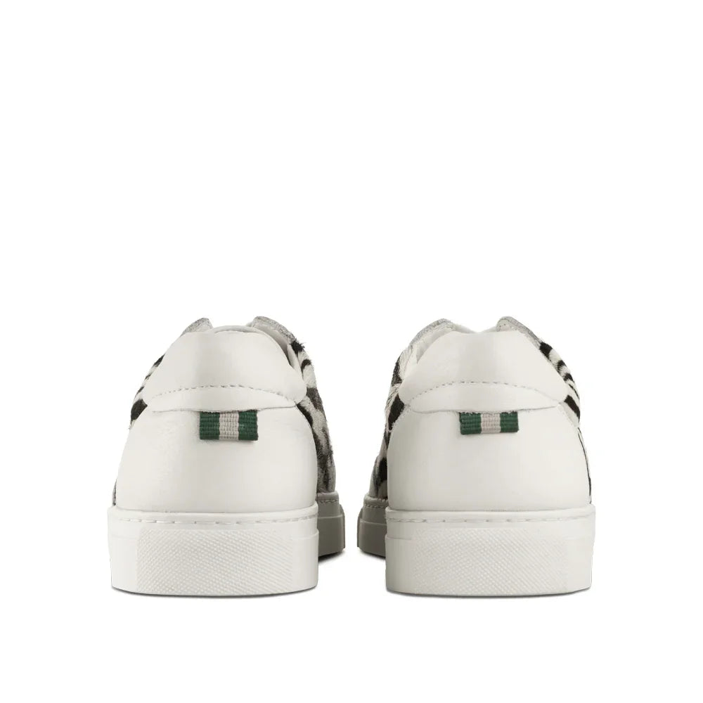 Back view of white leather sneakers with zebra print sides and green heel tab accents